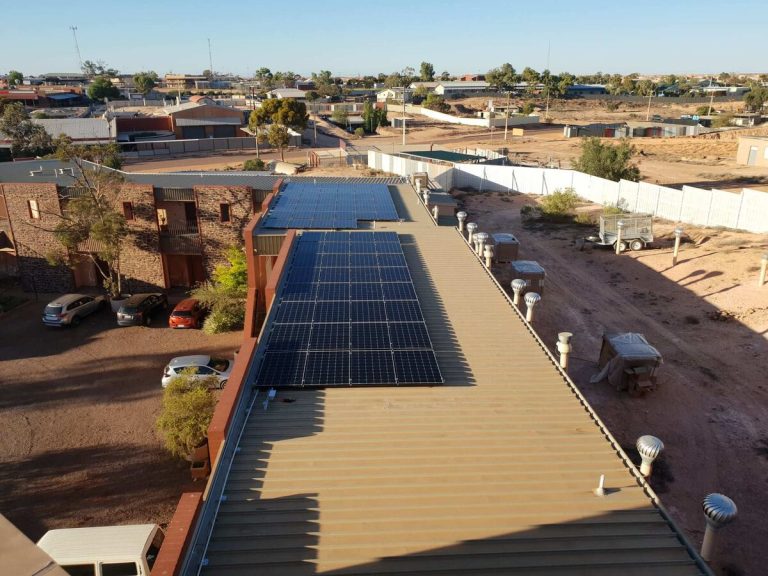Aerial view of a rooftop solar array on a commercial building