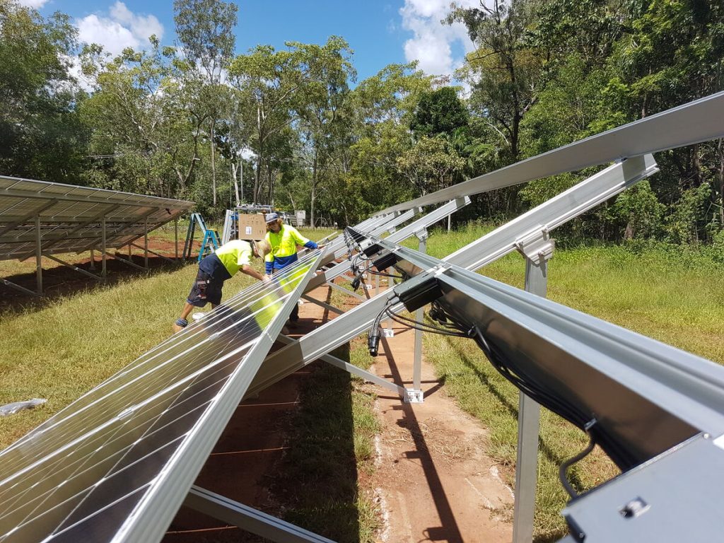 Crew assembling a ground mount solar frame