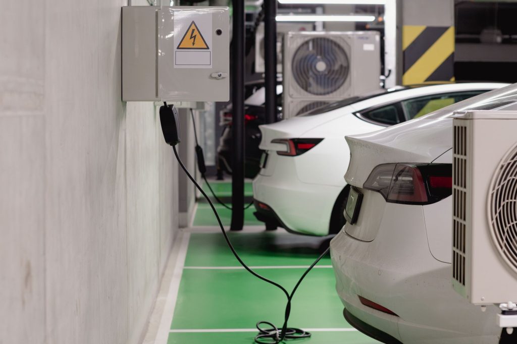 Electric vehicles charging at wall mounted units in a parking garage