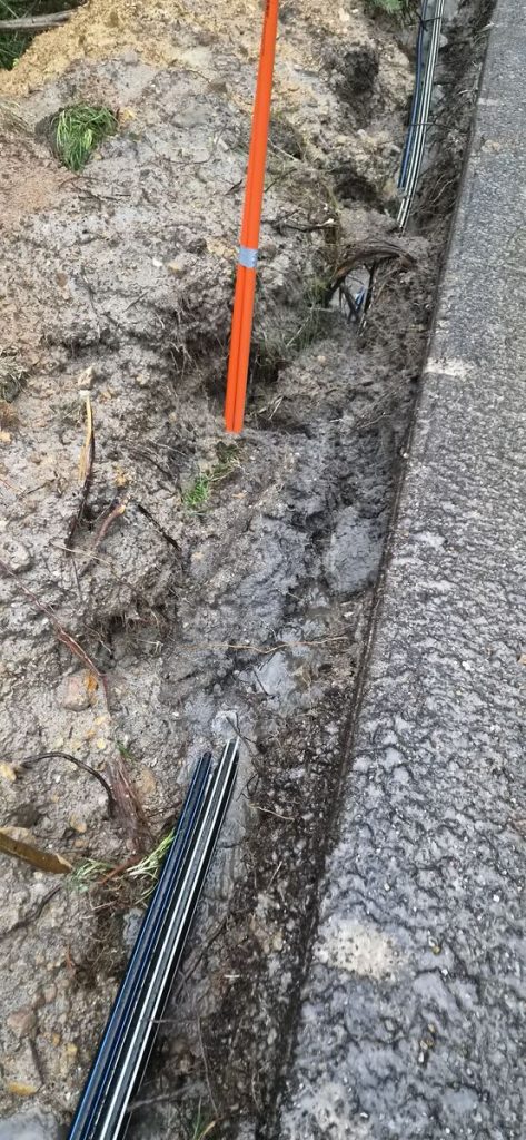 Underground electrical conduit laid in a roadside trench